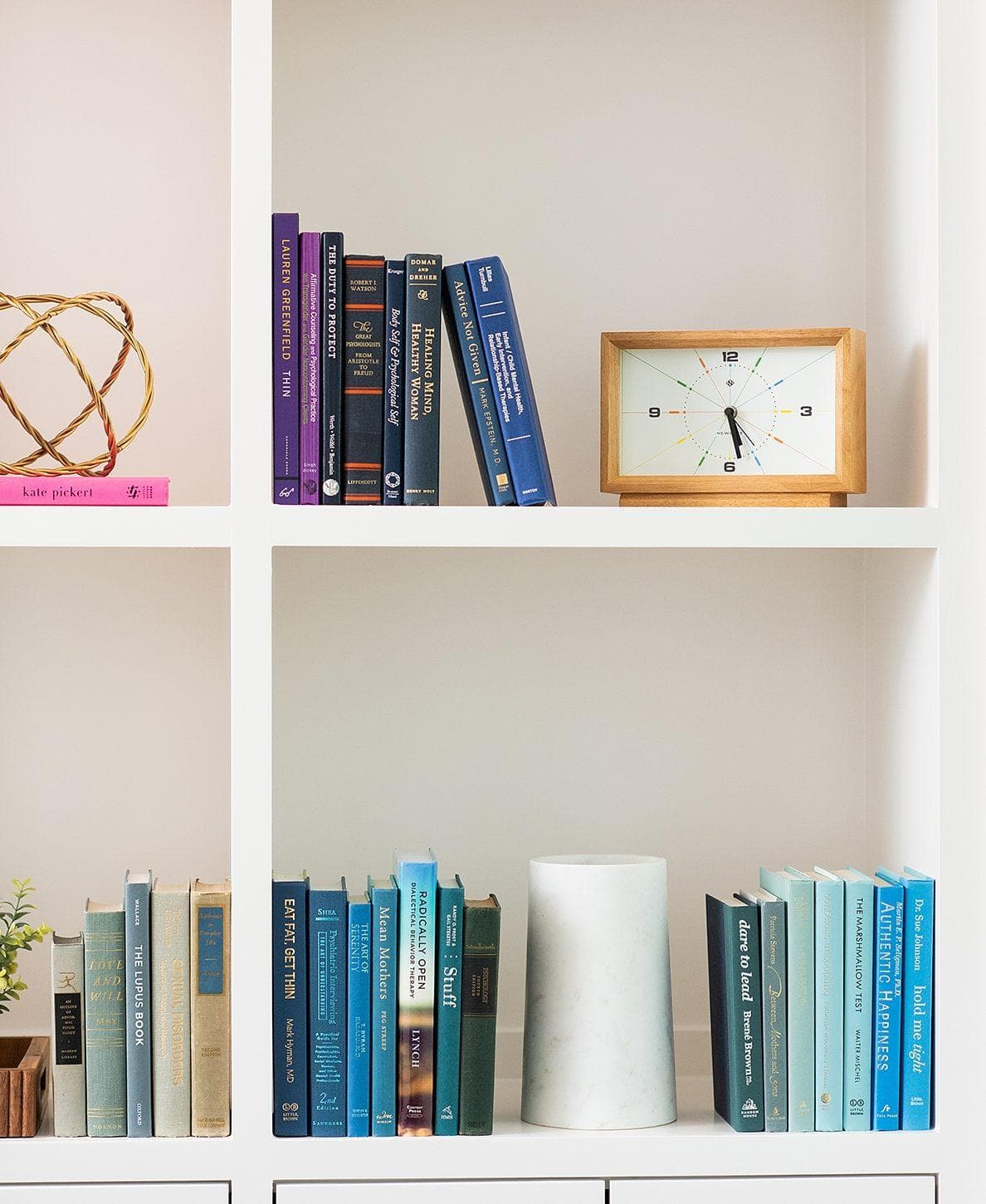Decor items on a white bookshelf